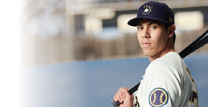 Christian Yelich in a brewers uniform with a baseball bat over his shoulder