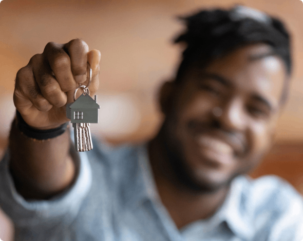 Happy man showing off the key to his new house.