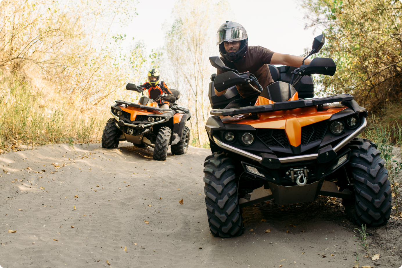 Friends riding atvs in a sandy area