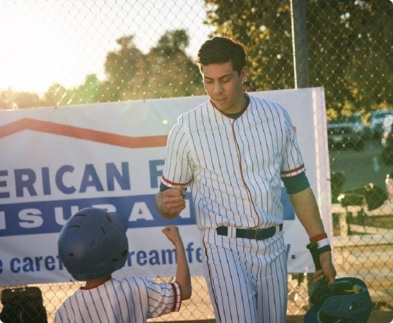 a baseball player talking to a catcher