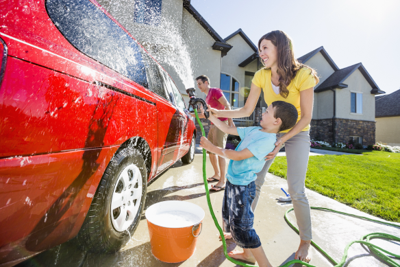 a person and a child washing a car