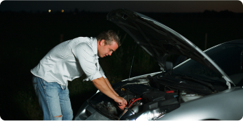 a man working under the hood of a car
