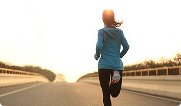 a woman running on an open road