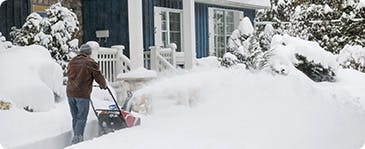 A person using a snow blower