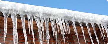 a group of icicles from a roof