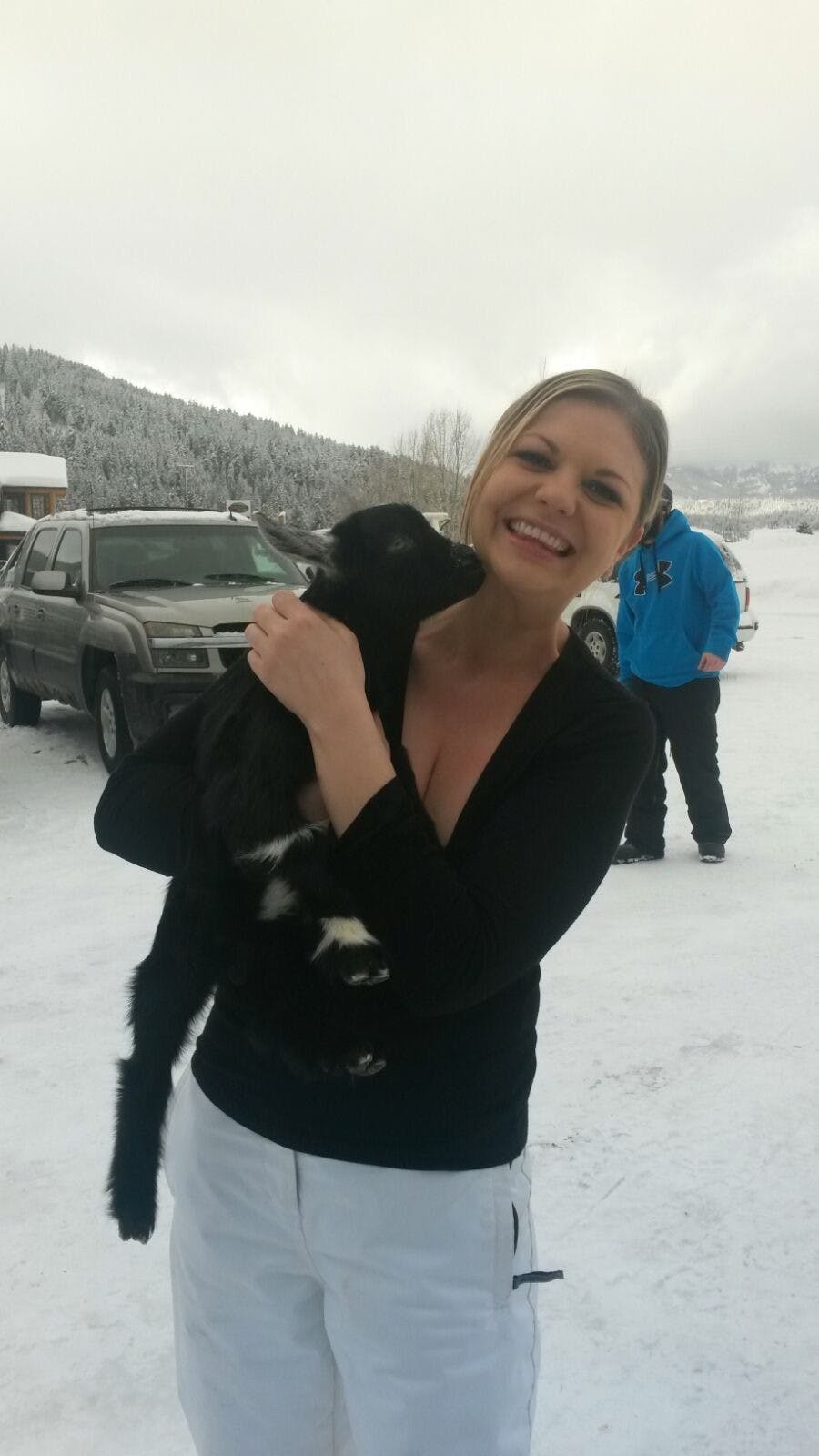 a person holding a dog in the snow