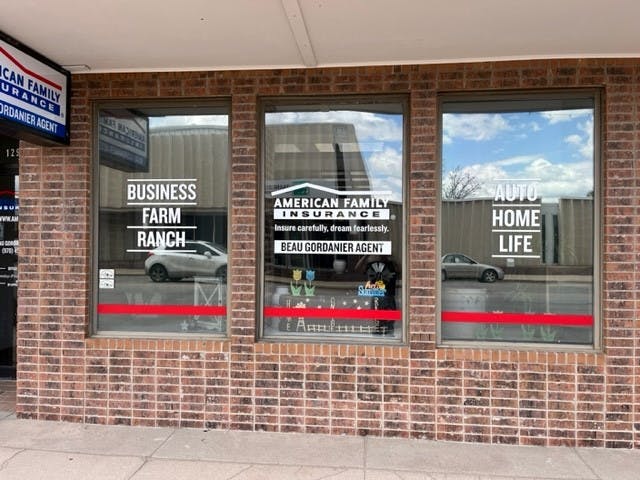 a brick building with a sign on the window