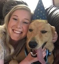 a woman and a dog wearing party hats