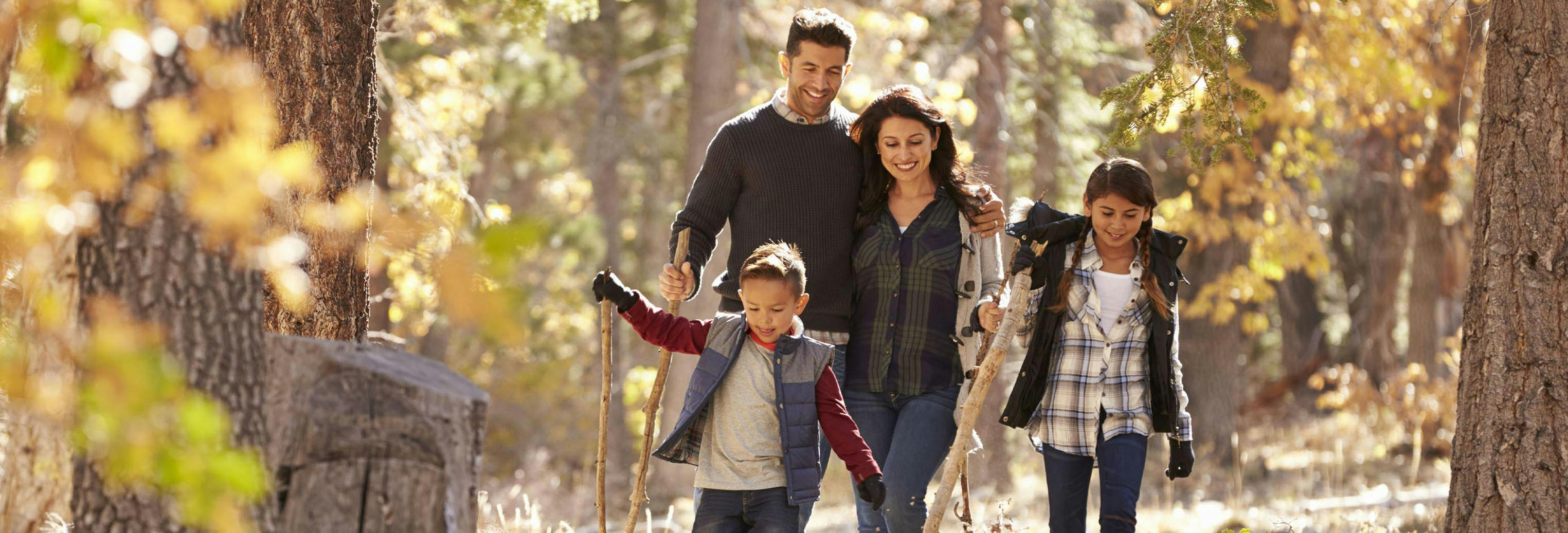 Family walking in the woods during fall