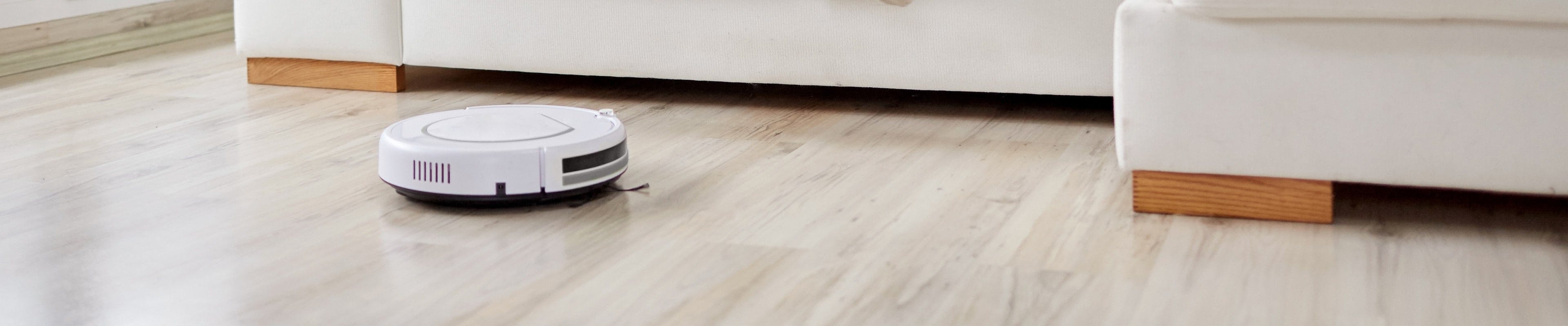 Smart vacuum cleaning the living room floor.