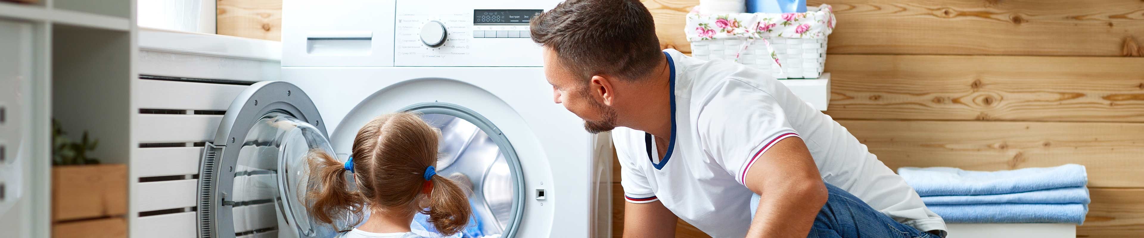 Dad and daughter doing laundry together
