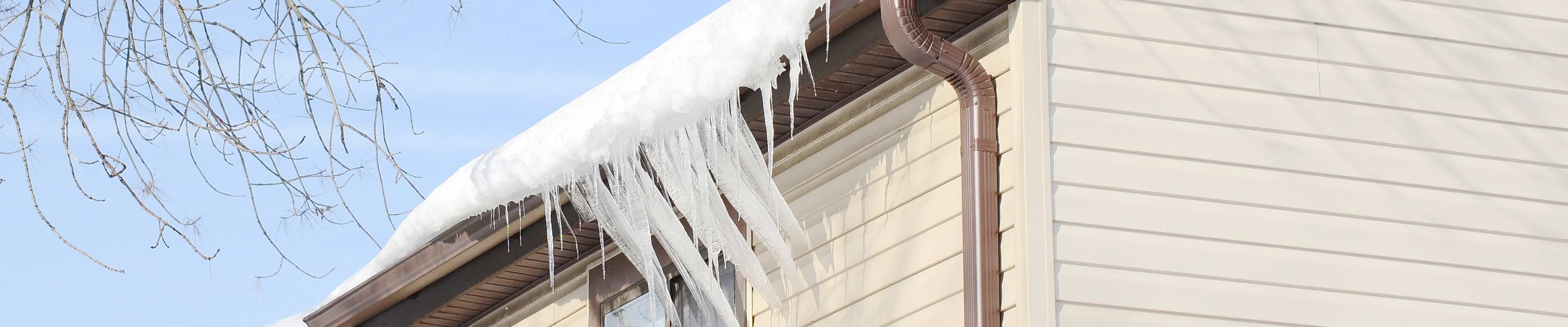 Image of a home with ice dams and icicles.