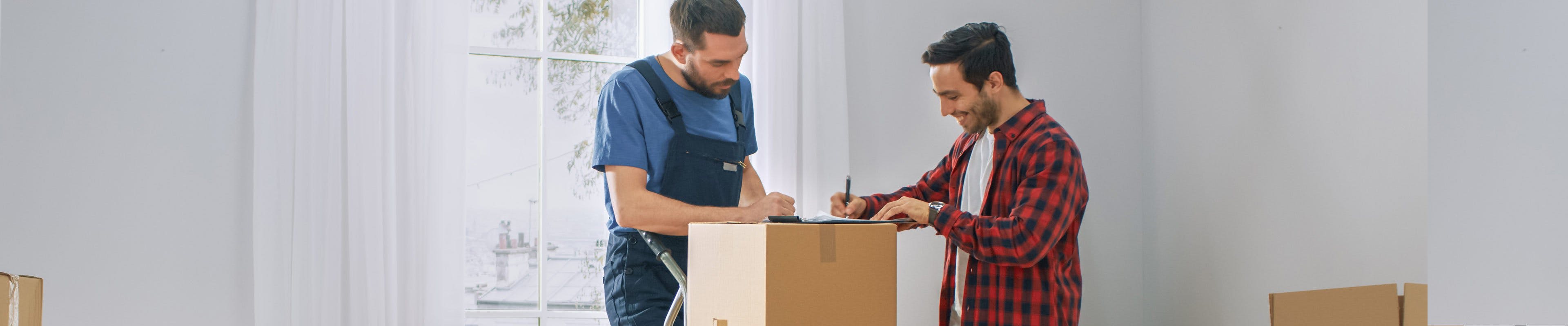 Image of a homeowner signing a moving contract with a mover.