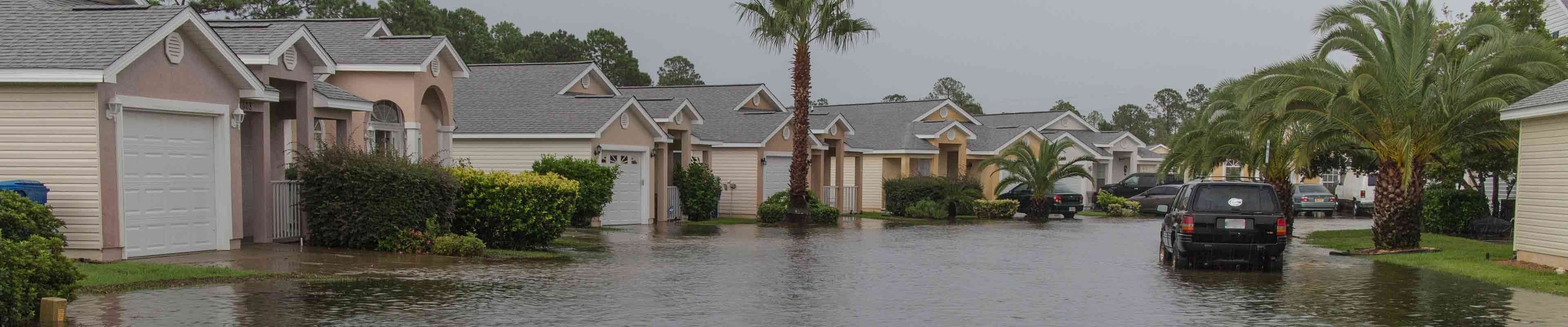 A row of houses with flooded basements in a neighborhood impacted by a heavy rainstorm.