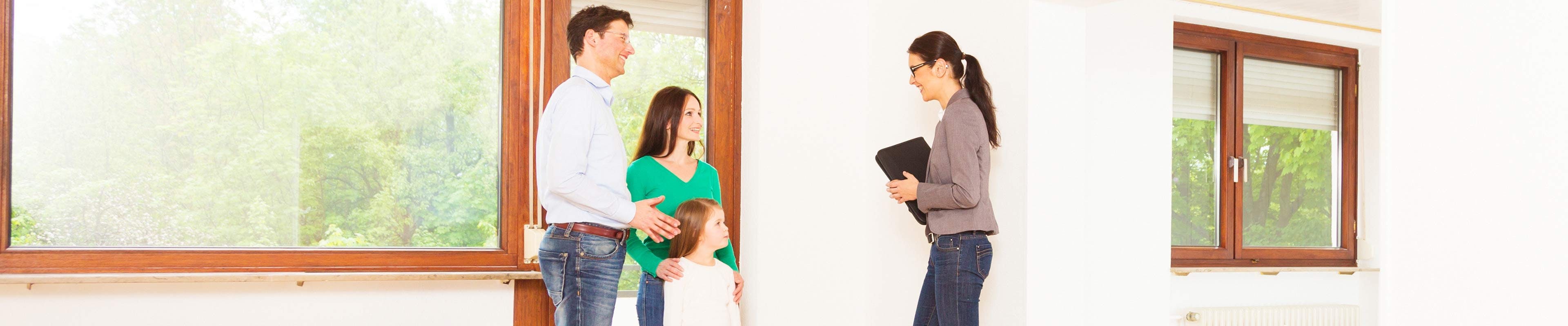 Young family looking at a house to buy.