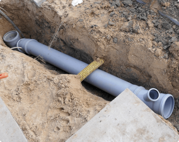 New sewer pipe being installed in the ground.