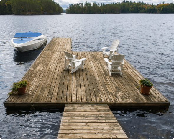 A boat dock with chairs on it. 