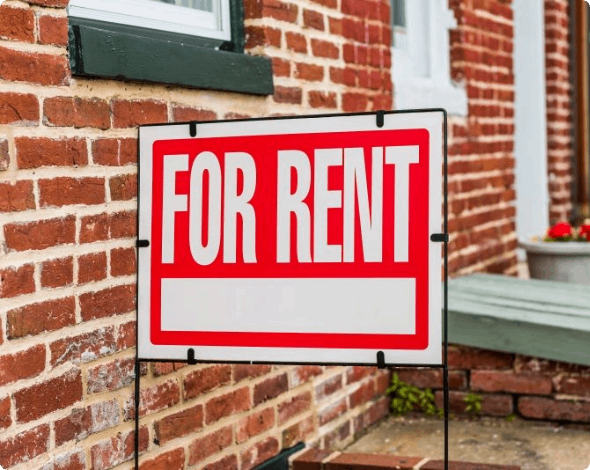 For rent sign, in front of a rental property. 