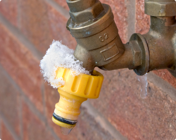 a frozen outdoor water spigot