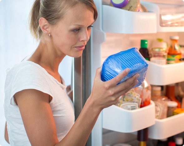 a woman checks food expiration date