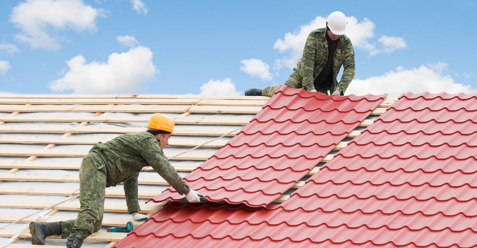 Men installing a metal roof