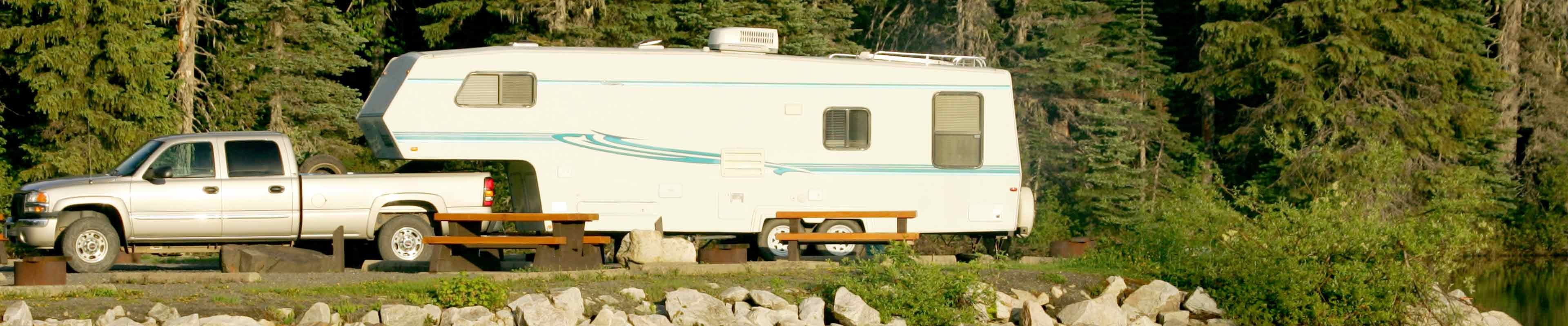 American Family Insurance | Image of a RV Camper parked on river.