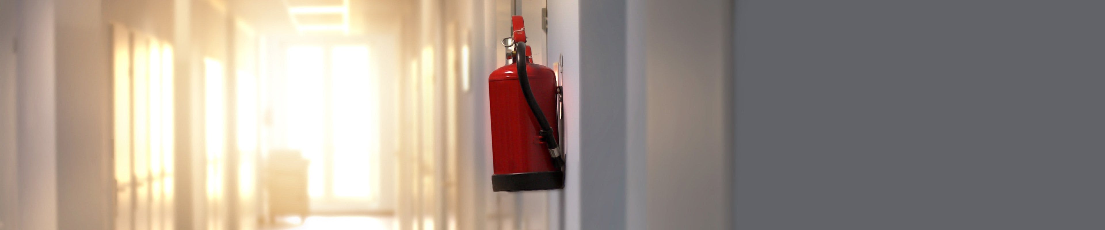 Fire extinguisher in hallway as part of an emergency response plan.