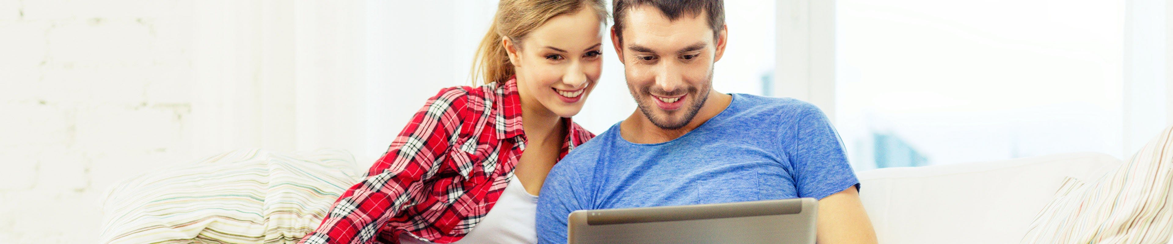 Young couple searching life insurance on computer