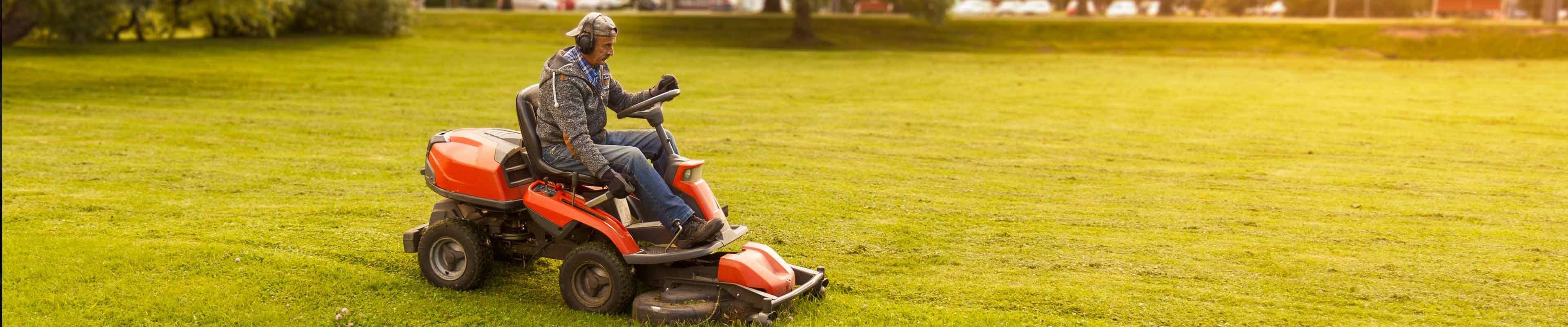 American Family Insurance | Image of a man in protective gear riding a lawn mower.