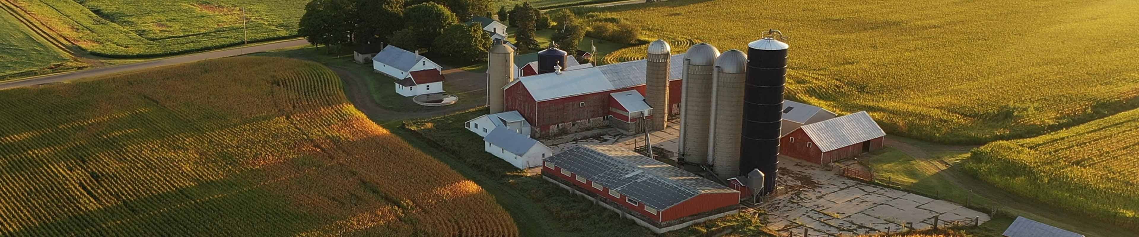 Image of an aerial view of a modern American farm during harvest season.