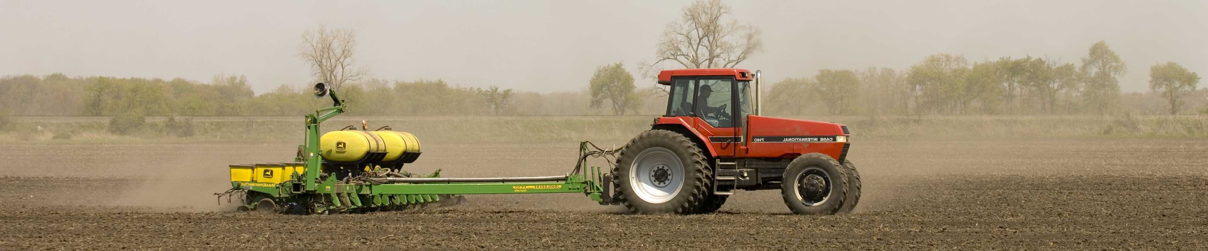 Image of a tractor and planter in a field.