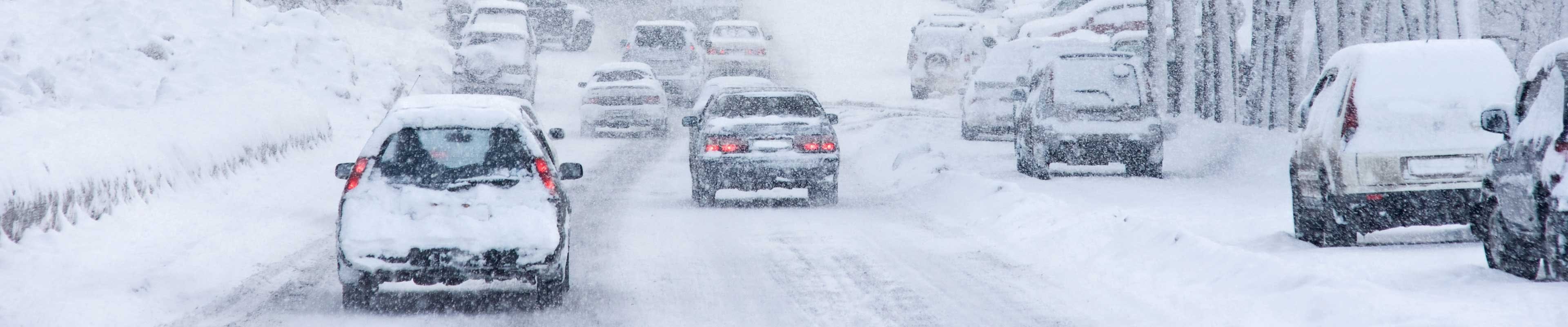 cars driving in snowy winter conditions