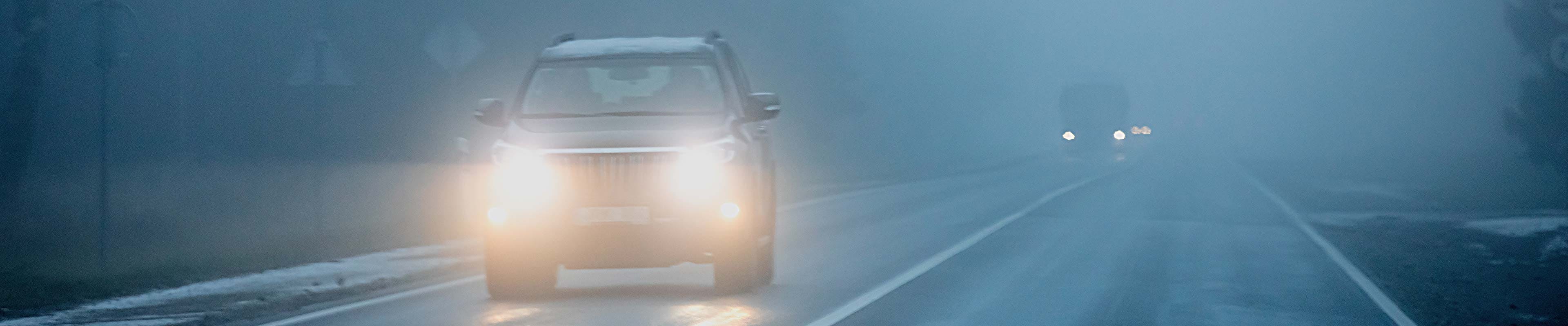 Car driving safely in the fog. 
