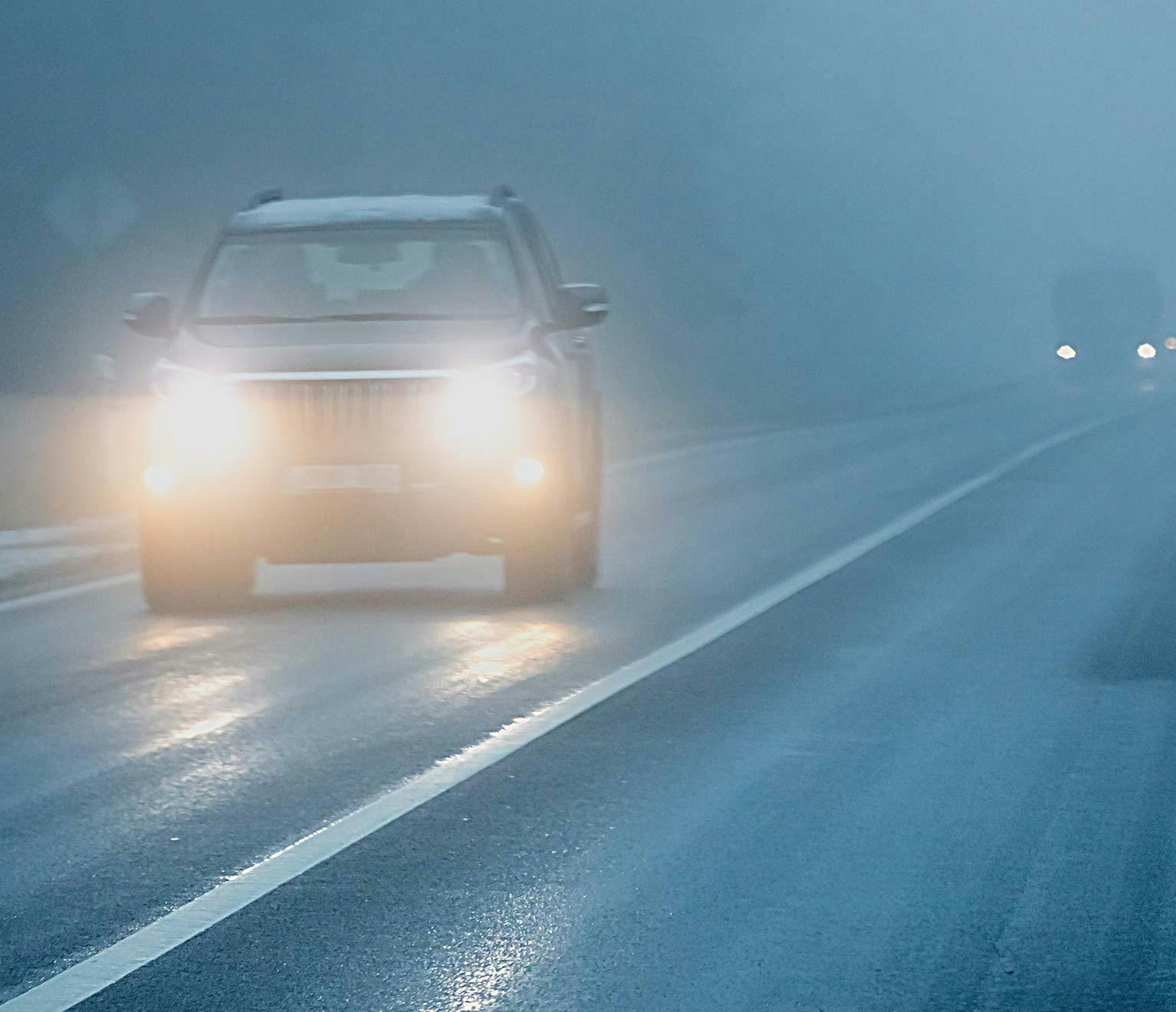 Car driving safely in the fog.