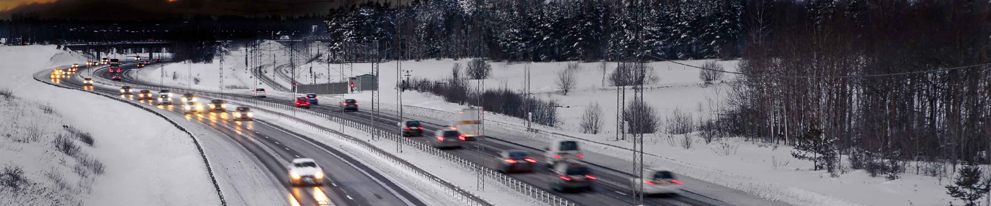 Heavy traffic on snowy, wintery roads.