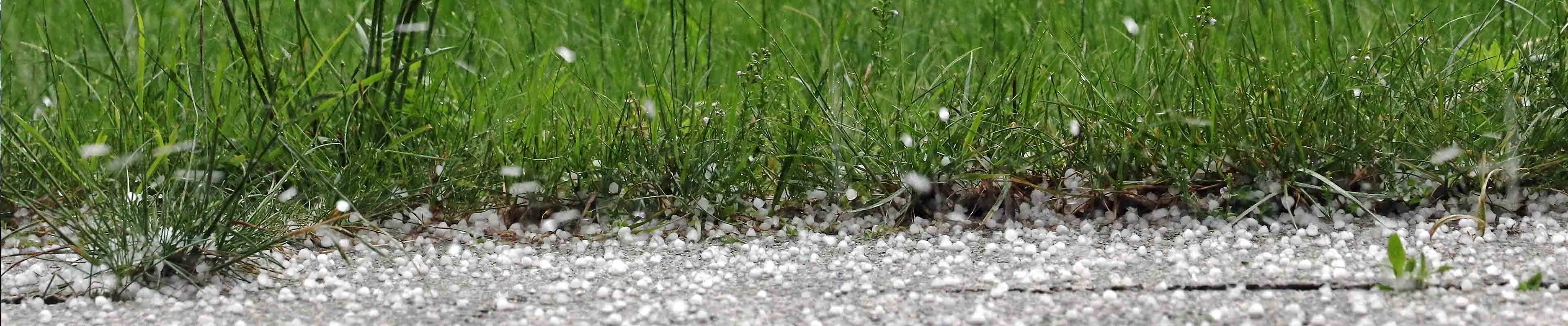 Dangerous hail falls outside during a thunderstorm. 