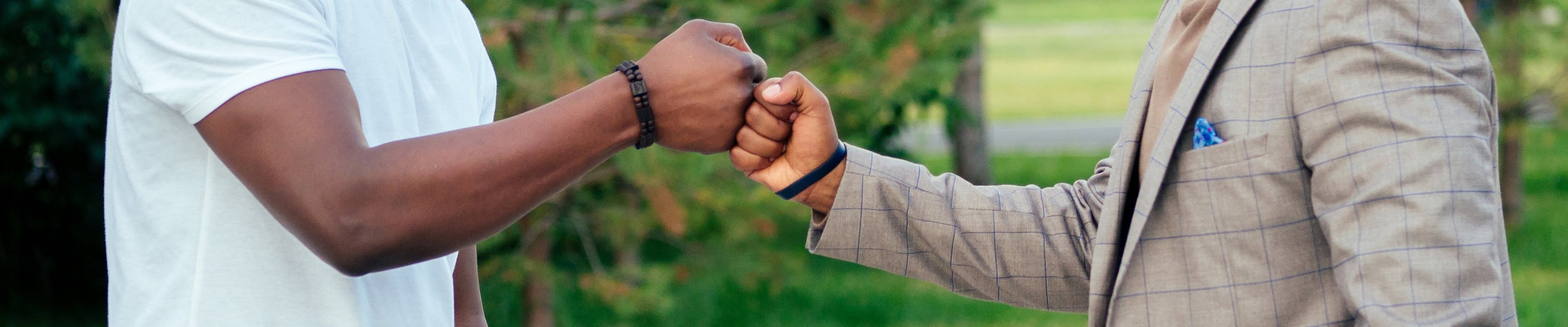 Two men fist bumping with each other