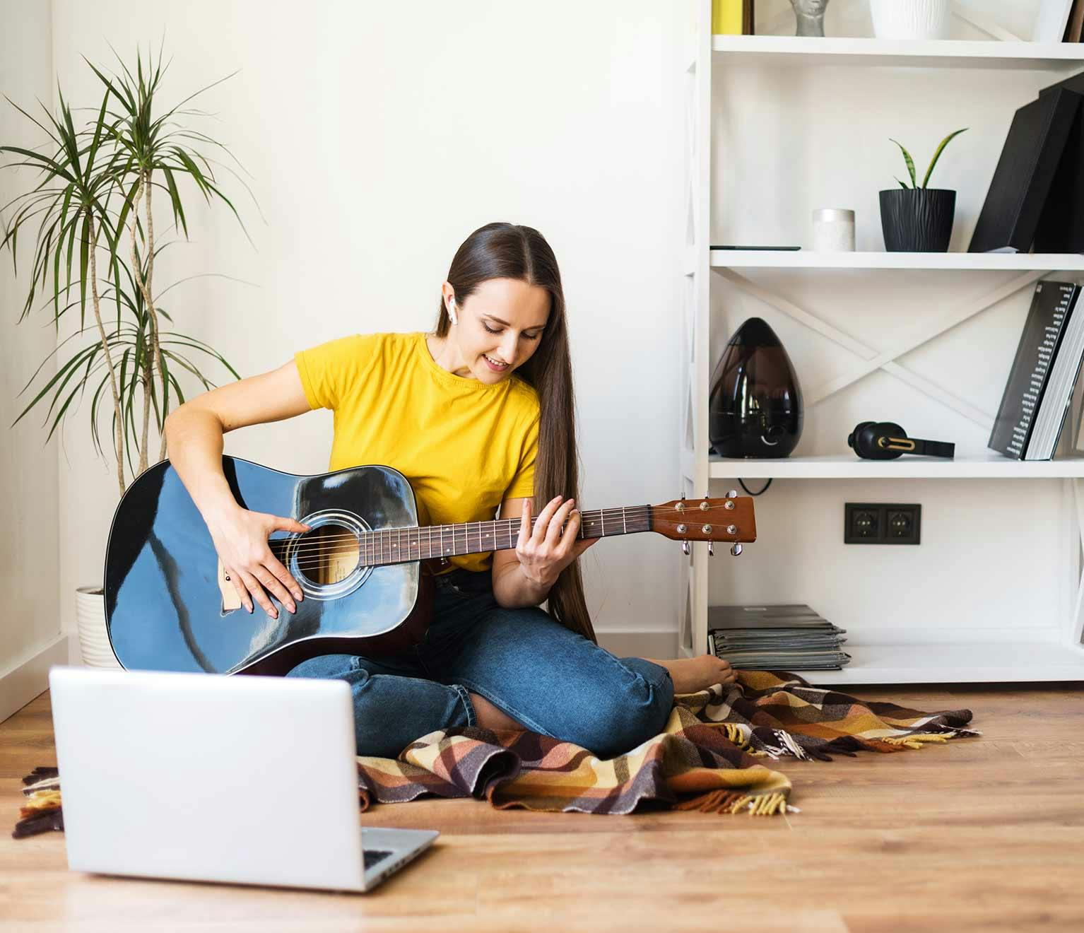 Woman learning to play guitar for her personal development plan