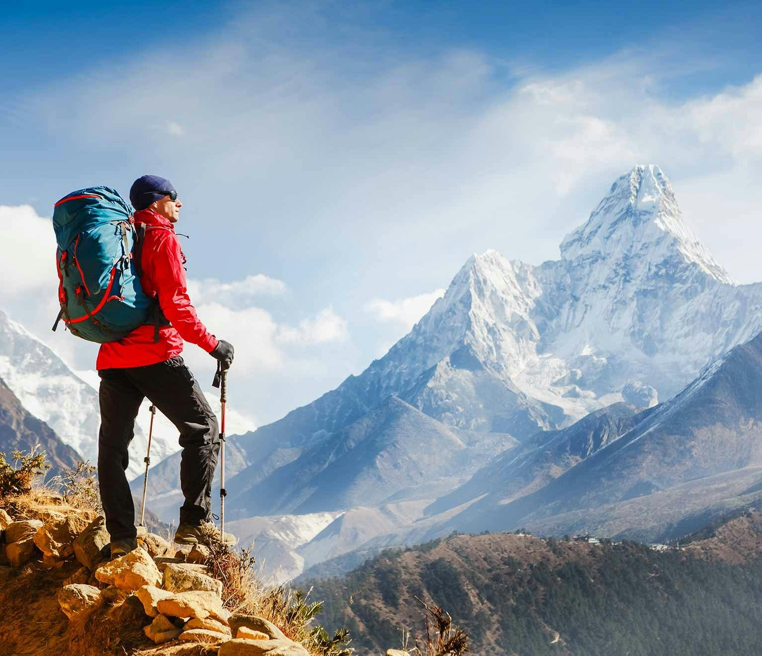Man climbing mountain and achieving life goal 