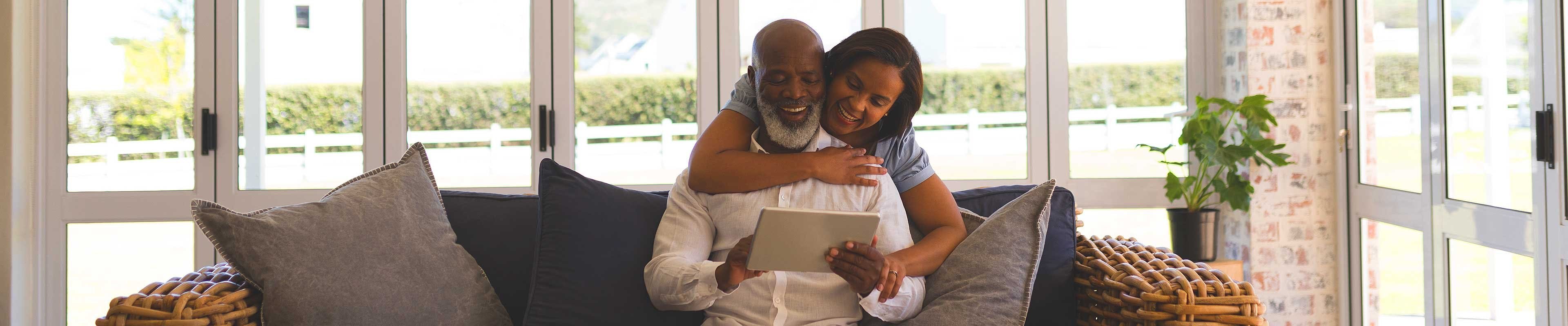 Couple looking online at their home insurance savings.