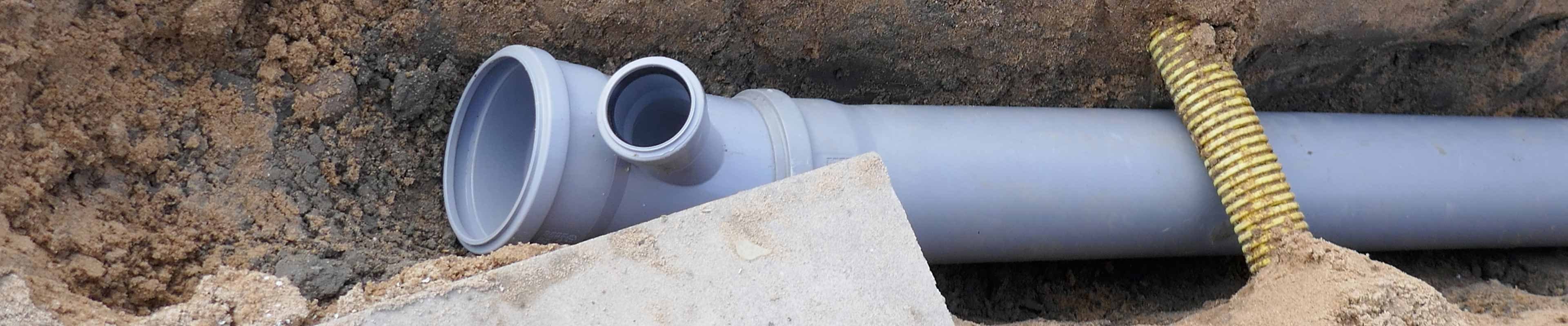Image of a sewer pipe being installed in a homeowner's front yard.