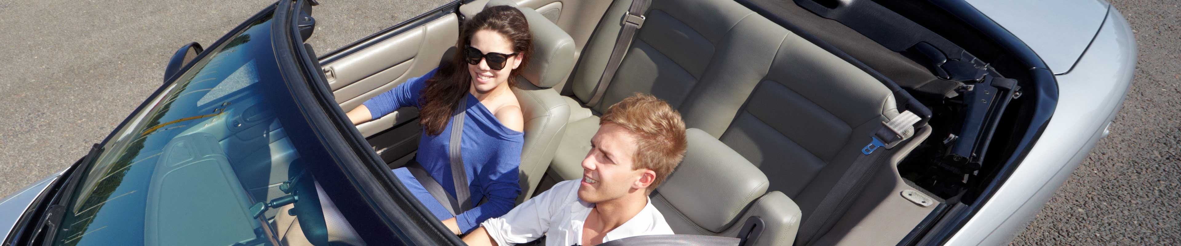 Image of a couple test driving a car.  