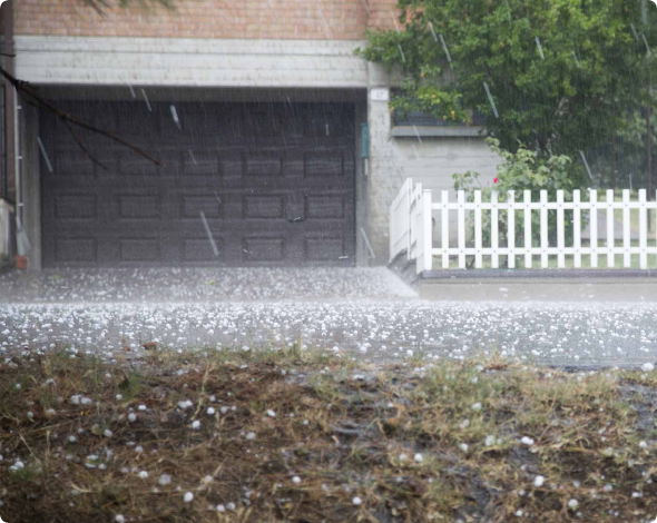 hail falling in front of a house