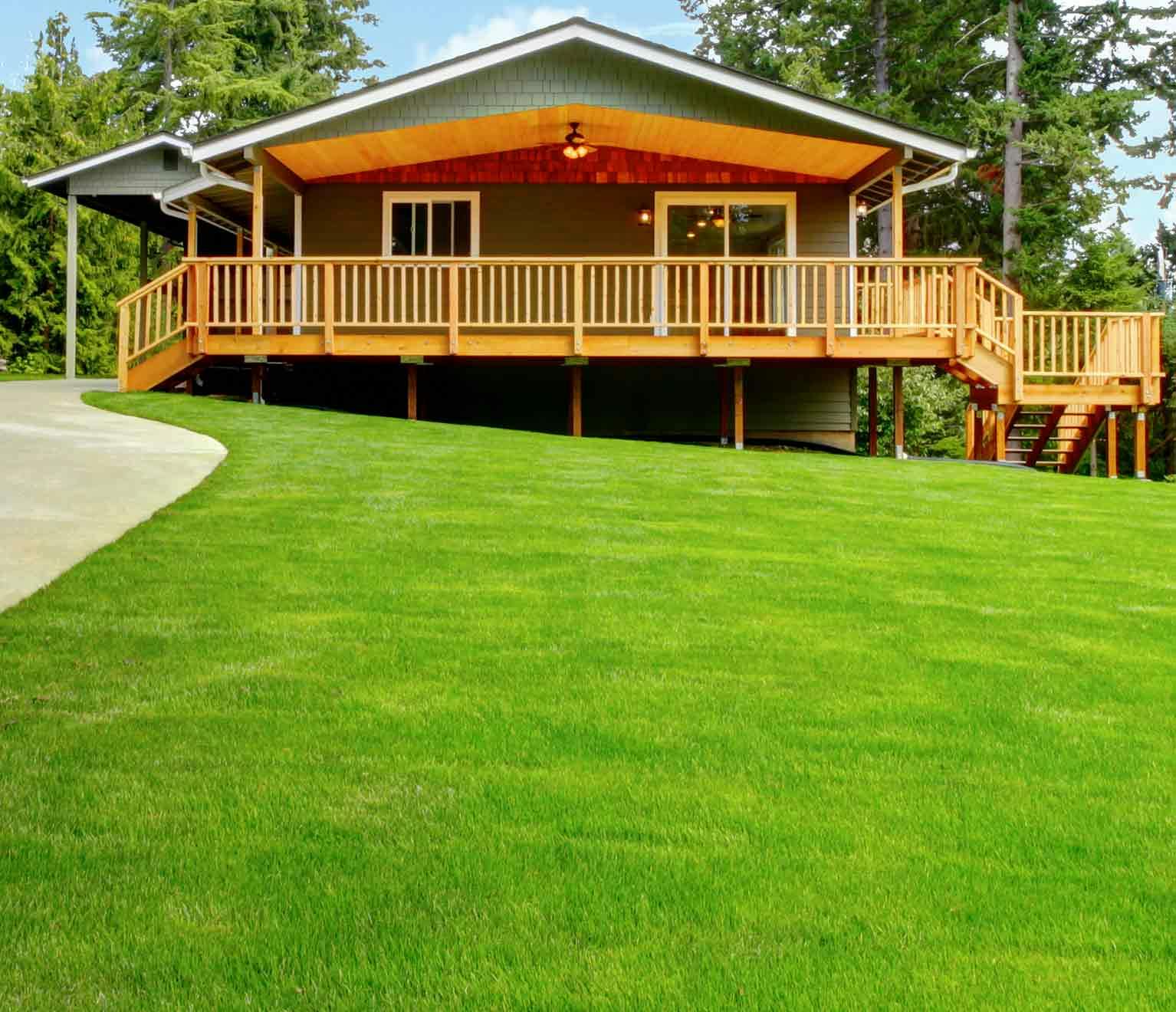 house with wraparound porch in the woods