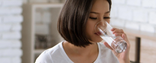 a woman drinking from a glass
