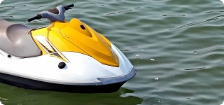 a yellow and white boat in the water