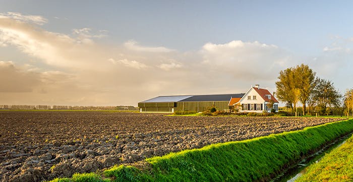 a house next to a field