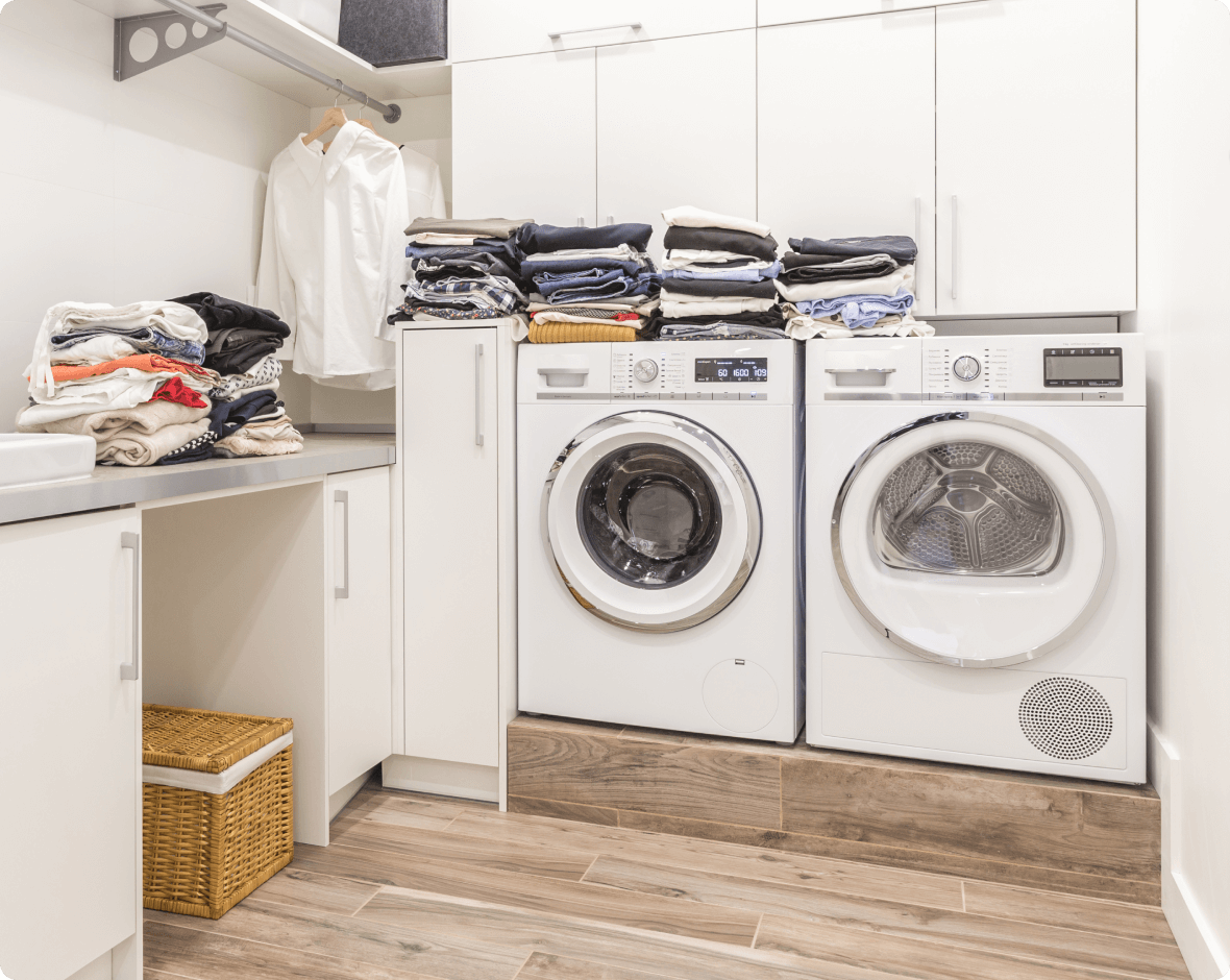 a laundry room with a washing machine and clothes