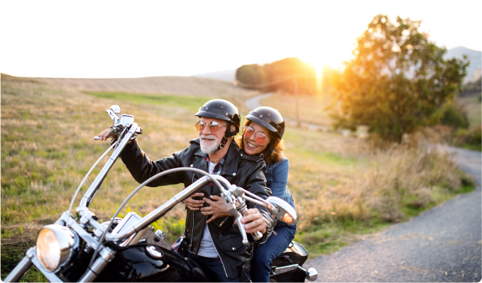a senior couple riding a motorcycle