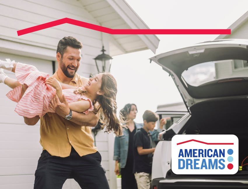 A man holding a child with American Dreams logo